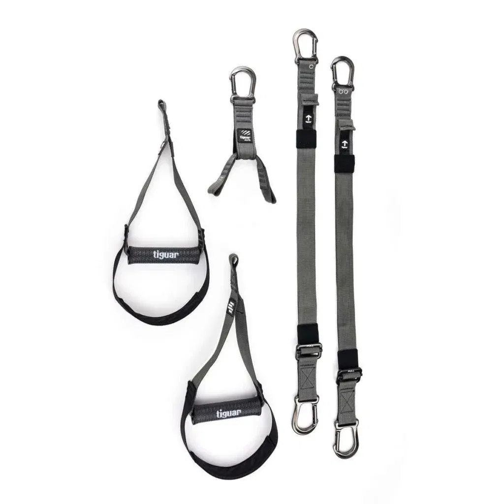 Zwei graue verstellbare Riemen mit Karabinerhaken, zwei schwarze und graue Fußfesseln und ein kurzer Verbindungsriemen, alle vor einem weißen Hintergrund. Die Gegenstände scheinen Fitness- oder Suspensionstrainingsgeräte zu sein.